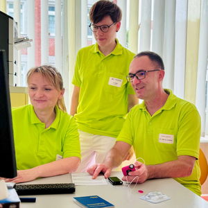 drei Ärzte sehen gemeinsam auf Monitor